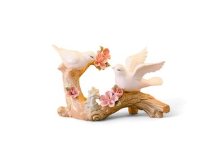 Decorative miniatures of two birds flapping their wings on wood with a white background