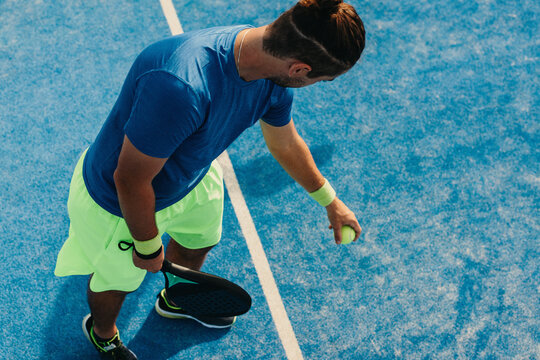 Padel player preparing to hit a serve on the court