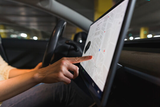 Hand of woman using touch screen navigation in car