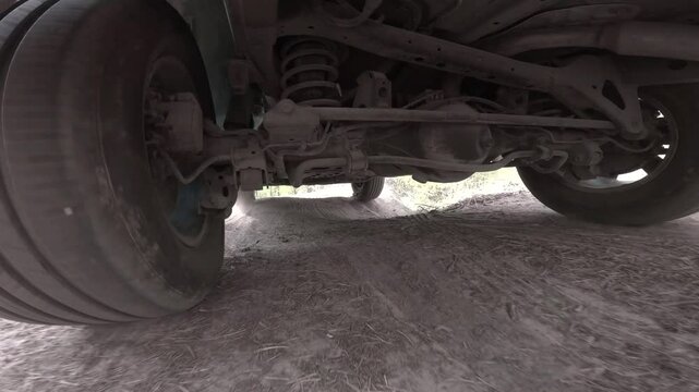 The operation of the car suspension in motion. Camera on the bottom of the car
