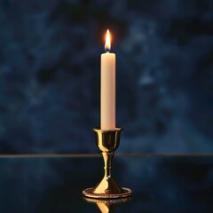 Lit candle in a golden candlestick