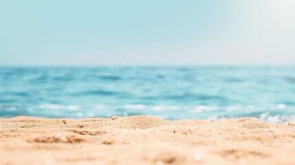 Close-up of sand foreground with blurred ocean and sky, evoking peace and the essence of summer days