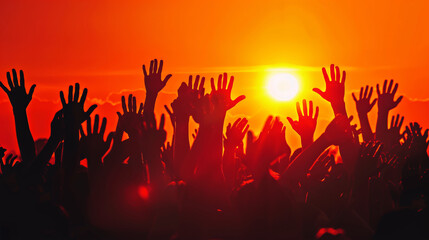 Crowd of Raised Hands at Sunset in Silhouette
