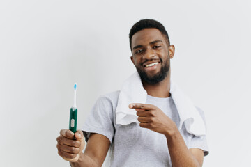 Smiling man demonstrates digital thermometer for temperature check