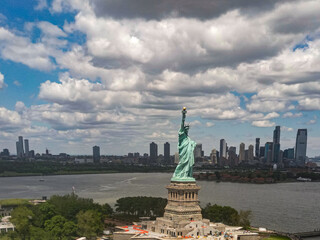 Panoramic aerial view Statue of Liberty in New York City, NY, USA. The Statue of Liberty over the Panorama of NYC. New York city skyline with statue of Liberty. The statue of Liberty and Manhattan. © Volodymyr