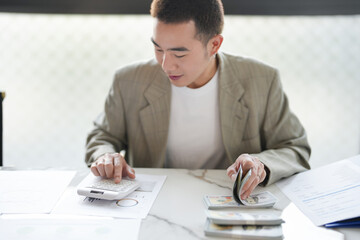 Confident asian business man Auditor or internal revenue service staff checking annual financial statements company Audit  Accounting tax