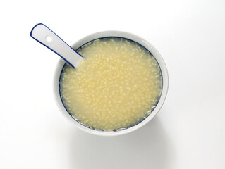 A bowl of nutritious breakfast millet porridge on the white table