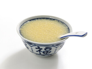 A bowl of nutritious breakfast millet porridge on the white table