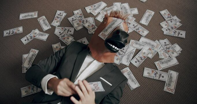 Businessman with horse mask counting stack cash money dollar profit salary wage earnings on workplace. Concept of salary or profit. Handsome happy businessman with horse mask scatters the dollars.