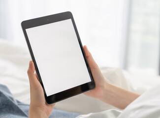 Hand holding digital tablet mockup of blank screen for graphic display montage.