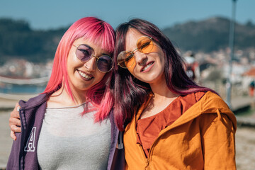 couple of loving lesbian women hugging on the street