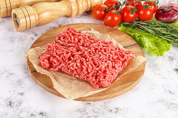 Raw minced beef meat on cutting board