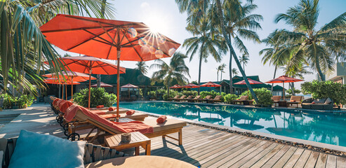 Happy tourism holiday landscape. Luxury beach resort hotel swimming pool, leisure lifestyle chairs under umbrellas palm trees, blue sunny sky. Summer island, relax poolside travel vacation background