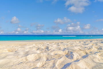 Closeup sandy beach, sunny blue sea sky. Panoramic beach landscape. Empty tropical beachfront and seascape copy space. White soft sand texture, calmness, tranquil relaxing sunlight, summer dream mood