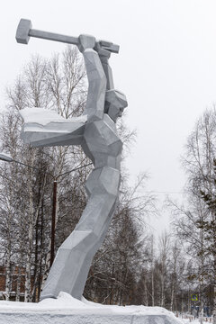Sculpture &ldquo;Bridge Builder&rdquo;, Tynda city, Amur region, Siberia, Russia - January 22, 2024. Monument dedicated to the builders of the Baikal-Amur Mainline (BAM). Sculpture of a man with a sledgehammer.