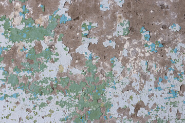 Peeling paint on the wall. Old concrete wall with cracked flaking paint. Weathered rough painted...