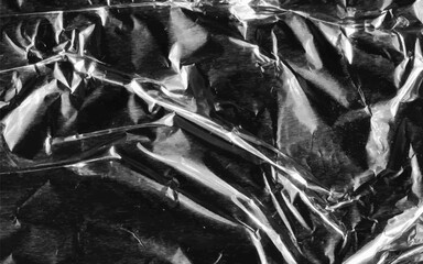Abstract transparent plastic wrap wrinkled texture on black background. Vector illustration vinyl, texture overlay effect of an old cover with defects and scuffs. Wrinkled, torn and old packaging.