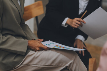 Group of young Asian business people brainstorm collaboration ideas at the office.