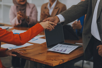 .Group of business workers smiling happy and confident. Working together with smile on face shaking hands at the office