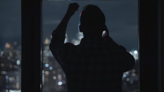 Man talking on the phone angry and upset, silhouette yelling and shouting angry. Manhattan skyline view at night. businessman fighting and arguing. speaking with someone on smartphone. lose money
