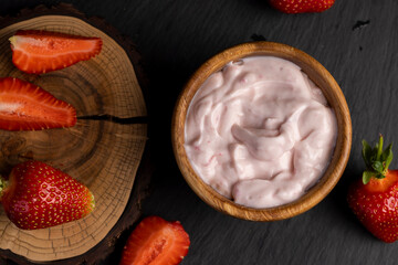 yogurt made from milk with added flavor and pieces of ripe strawberries