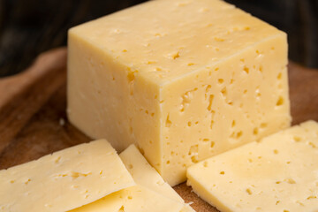 a piece of cheese with holes on the table