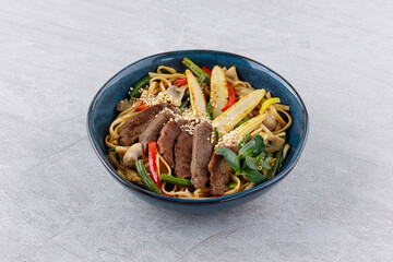 Udon noodles with beef and vegetables for the menu, website, restaurant or food delivery