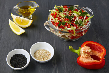 Appetizing vegetable salad of chopped cabbage and bell peppers with parsley and cumin seeds dressed with olive oil and lemon