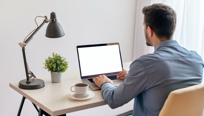 Back view of business man freelancer sitting in home office at table