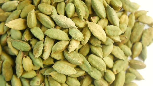 top view of rotating cardamom in a bowl 