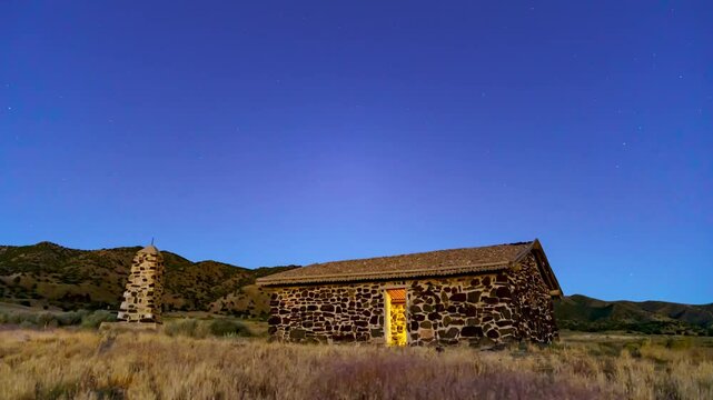 Historic pony express station cabin in the Utah desert under the Milky Way - panoramic day-to-night time lapse