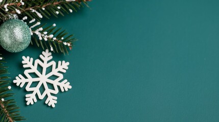 Pine branch with white snowflake ornament on green background. Christmas and New Year festive minimalist concept. Template for greeting card, invitation, banner with copy space.