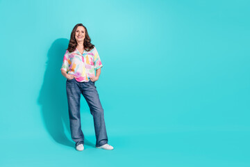 Full size photo of attractive senior woman posing model dressed stylish colorful clothes isolated on cyan color background