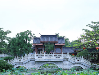 Lotus flowers and ancient Chinese architecture in summer lake