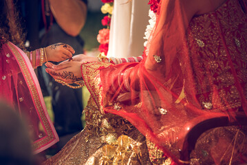 Traditional Indian wedding ceremony with cropped unrecognizable bride