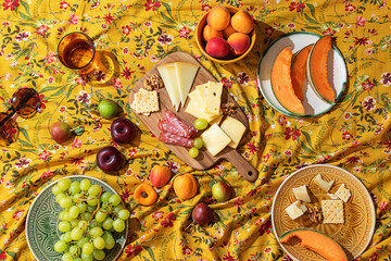 Colorful summer picnic spread on floral tablecloth