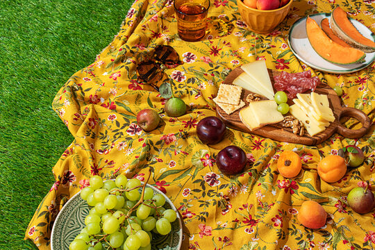 Colorful summer picnic setup on a floral blanket