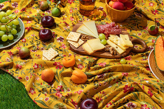 Colorful summer picnic spread on a floral tablecloth