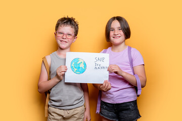 Two kids holding a Save the Planet sign in studio