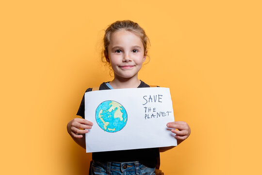 Young girl holding eco-friendly sign Save the planet