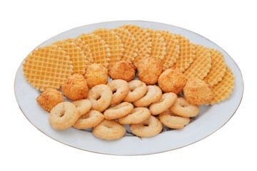 Variety of cakes and waffles in ceramic plate isolated on a white background. Golden romantic biscuit. Top view.