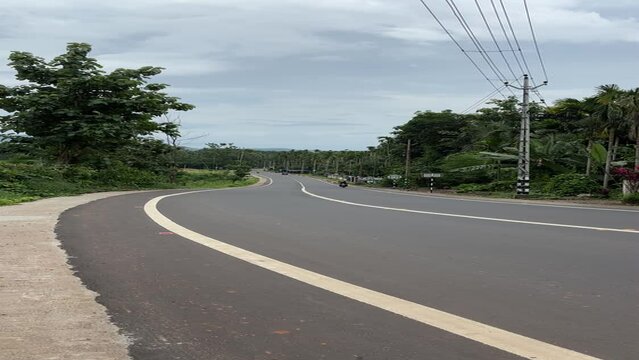 scenic view of the Kalikavu Karuvarakund or Malayora Highway road in Malappuram, Kerala, India. The winding road cuts through lush green landscapes and rolling hills, showcasing the region's natural 