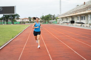 Fototapeta premium Asia mature woman runner training on racetrack and field 