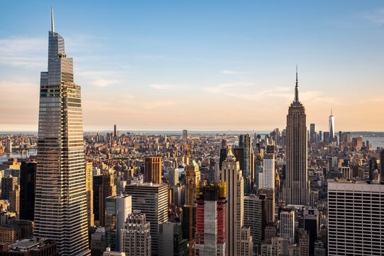 Golden hour view of New York City skyline with sunset