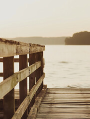 Wooden pier close-up | sunset light | calm lake in the background | warm tones | serene and peaceful | natural setting | outdoor photography | minimalistic composition | tranquil scenery | horizontal 