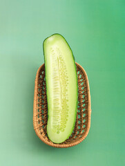 Fresh vegetable cucumber on green background