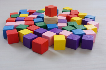 Obraz premium Inclusive leadership. A crowd of multi-colored cubes and one main one.