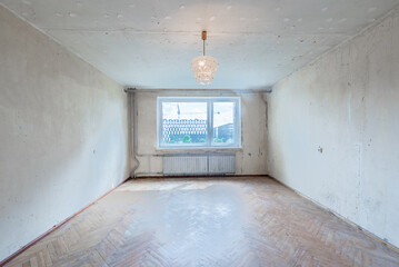 Living room in bad condition. Dirty Room. Old Soviet Russian Poor Interior. Shabby wooden floor.