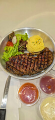 Luxurious glorious sirloin steak dinner with premium sides a feast for the senses along with potatoes, sauces and condiments good for recipes and cook book content