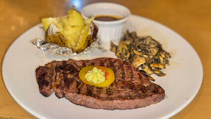 Luxurious glorious sirloin steak dinner with premium sides a feast for the senses along with potatoes, sauces and condiments good for recipes and cook book content